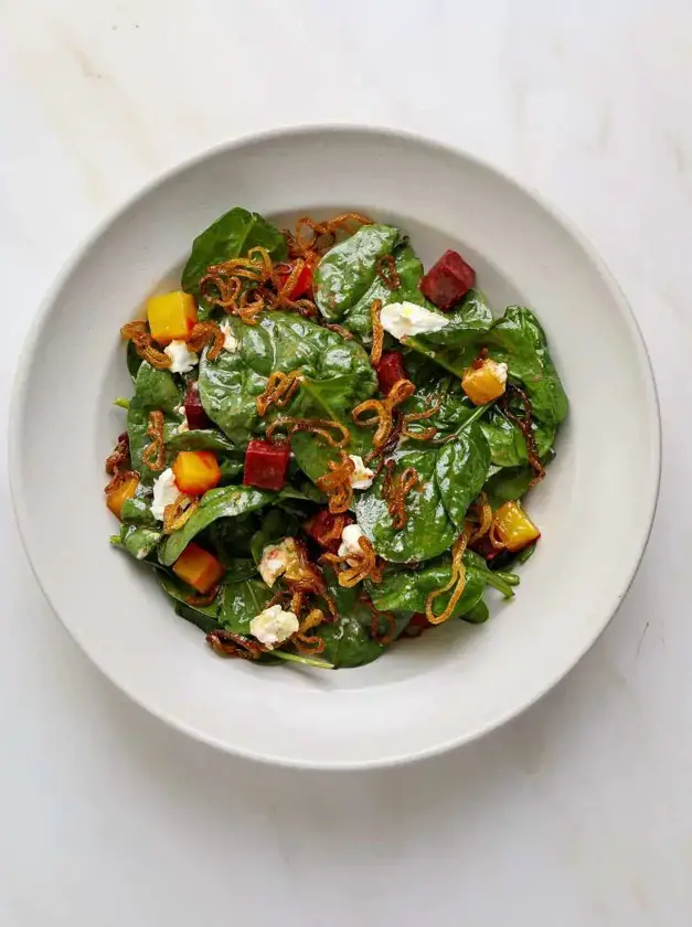 Warm Spinach Salad with Roasted Beets, Goat Cheese, and Crispy Shallots